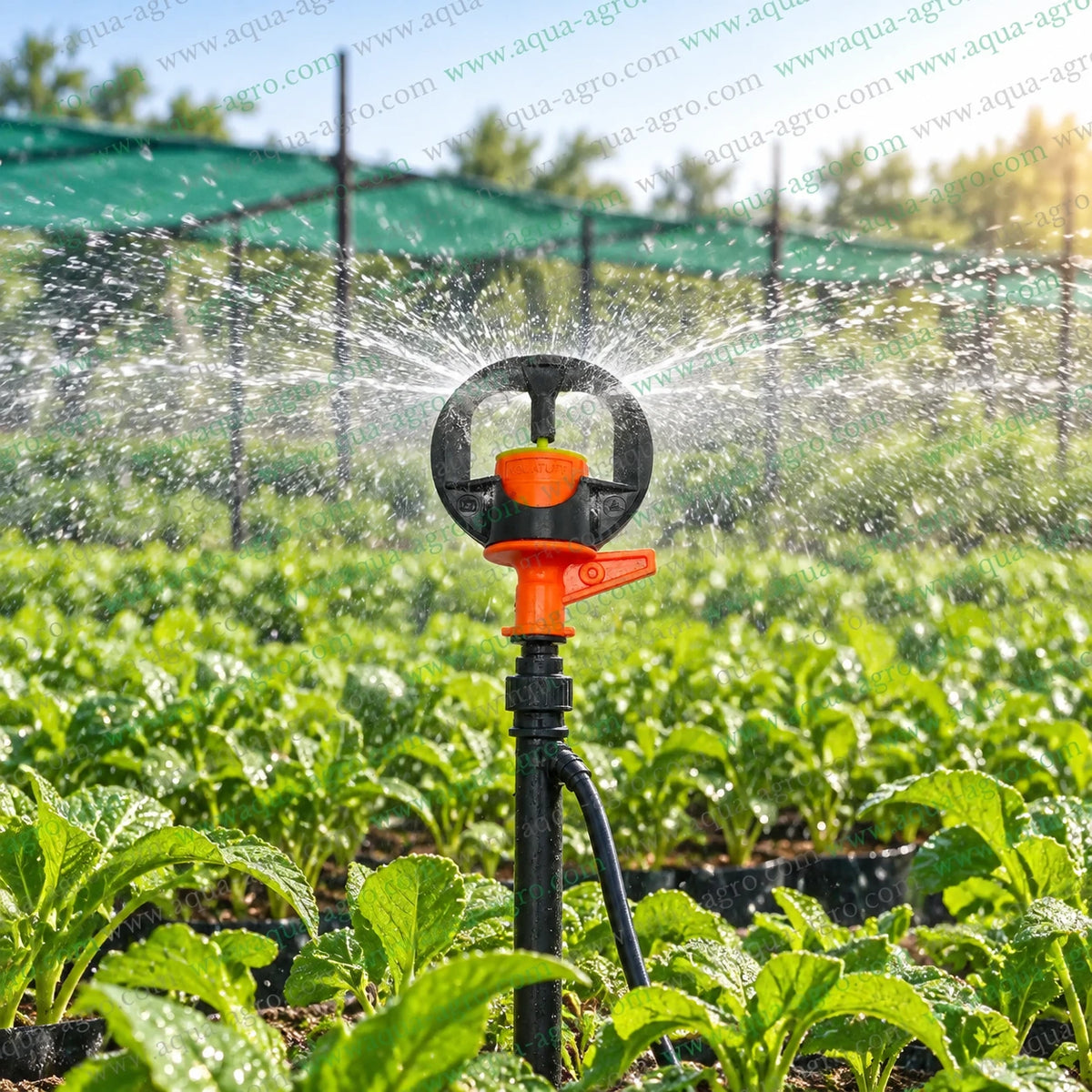 AUTOMAT Aquatuff HT-205 orange micro sprinkler operating in agricultural field with full circle 360 degree water spray and 12 to 16 feet radius