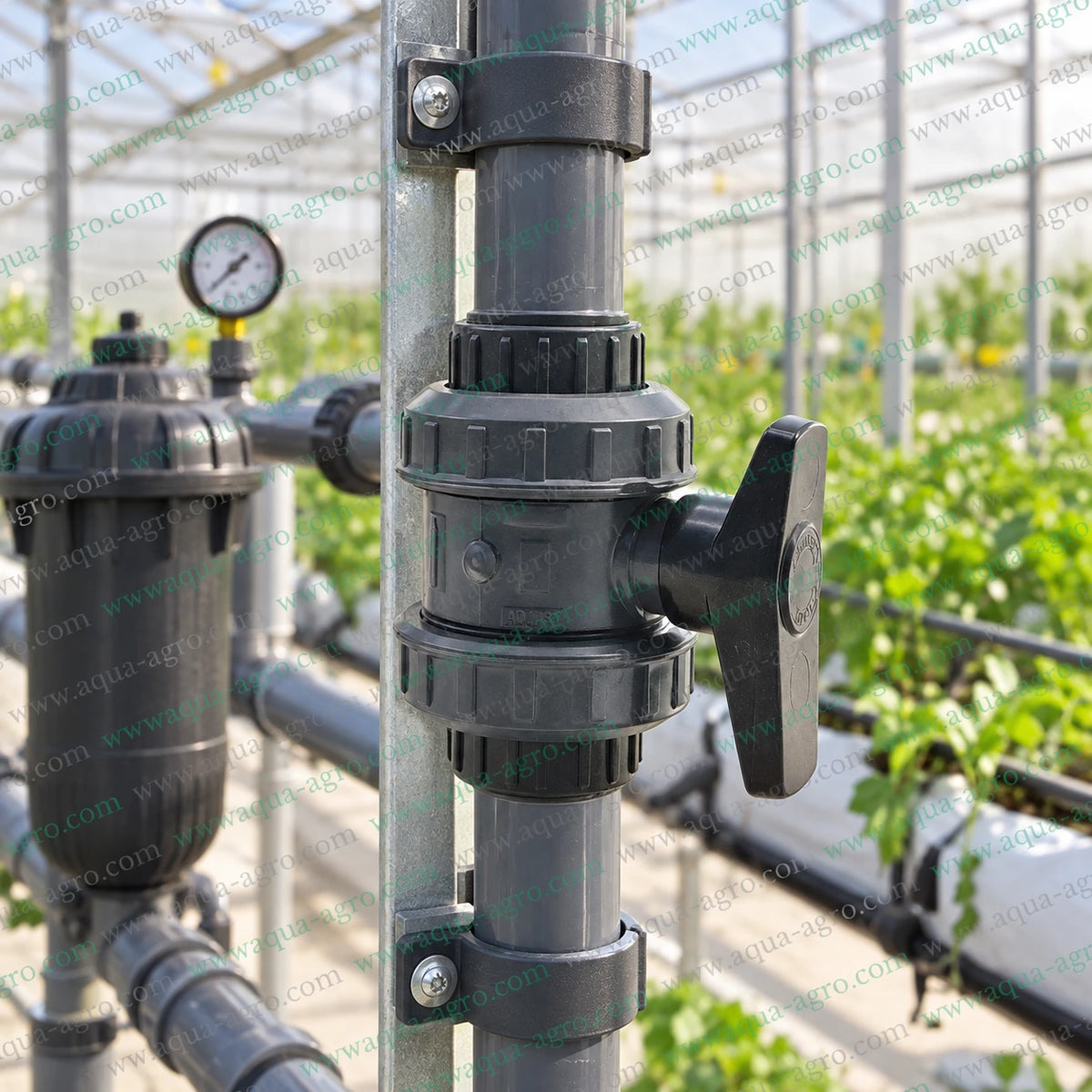 JAIN 1 inch (32mm) double union PVC ball valve installed on a greenhouse irrigation pipeline, suitable for drip irrigation, agricultural irrigation, fertigation, greenhouse plumbing, filtration systems and water distribution networks.