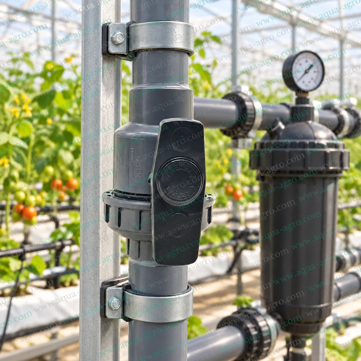 JAIN 1.25 inch (40mm) grey PVC single union ball valve installed vertically on a supported irrigation pipeline inside a greenhouse, suitable for agriculture, drip irrigation, filtration systems, water distribution and flow control.